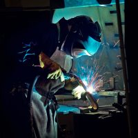 Clark track employee welding parts of a track